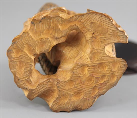 A Japanese boxwood okimono modelled as a dragon and a tiger, early 20th century, height 11cm, associated wood stand